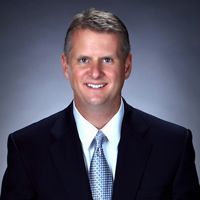Mr. Bruce A. Hausmann